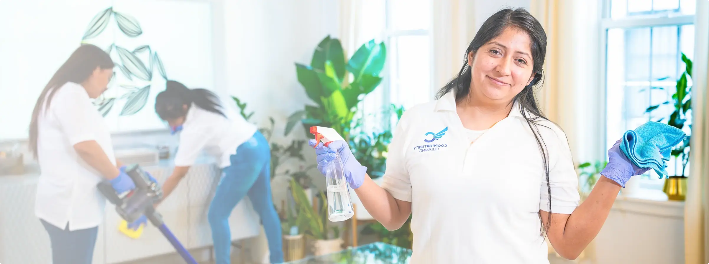Coopportunity Cleaning team members smiling and cleaning a bright, cozy living room, promoting pricing and promotions.